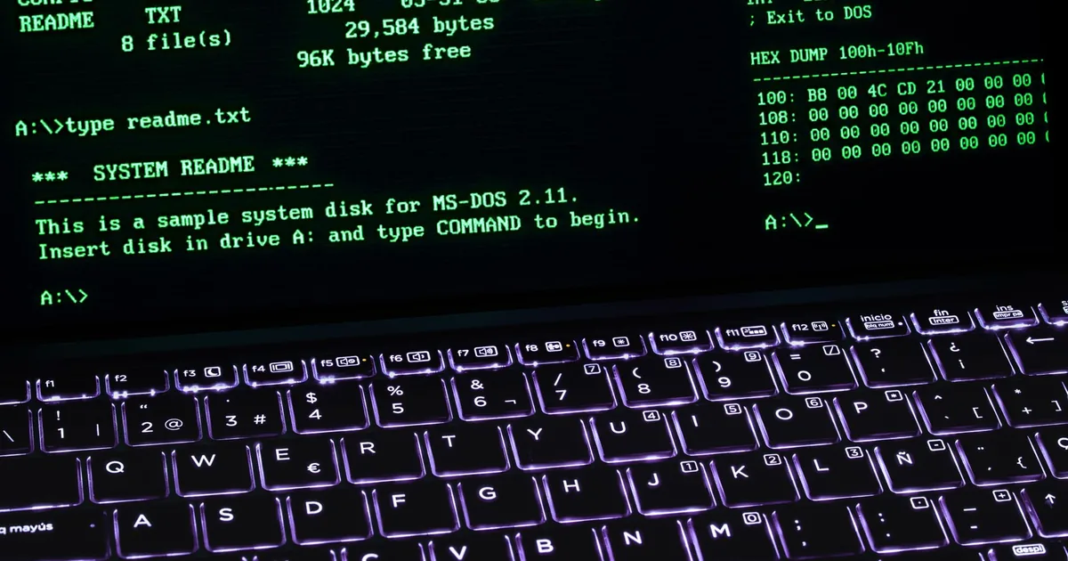 A terminal glowing on a desk in the evening, with a mug beside it